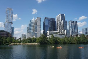 lake with kayakers in front of buildings