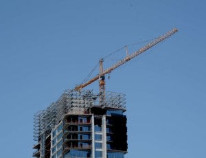building under construction with crane