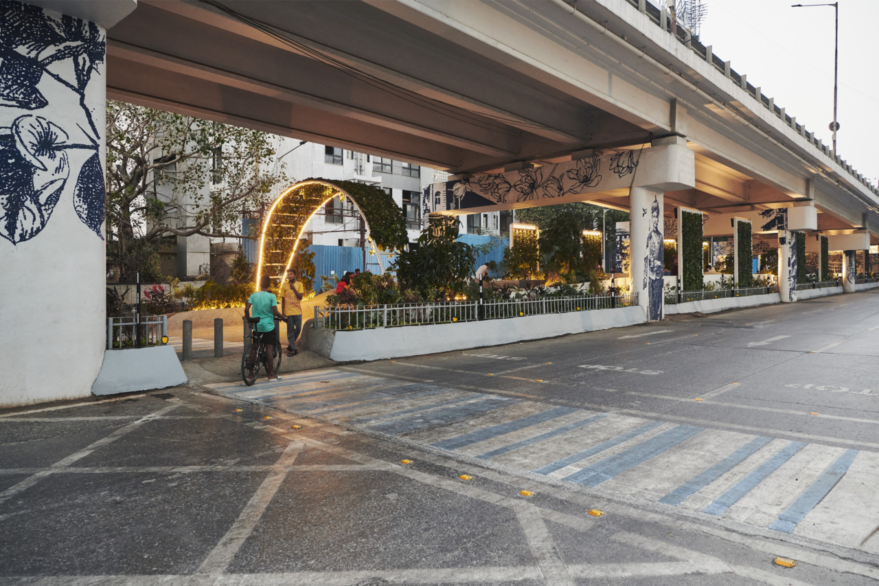 view of a public space tucked beneath an elevated highway