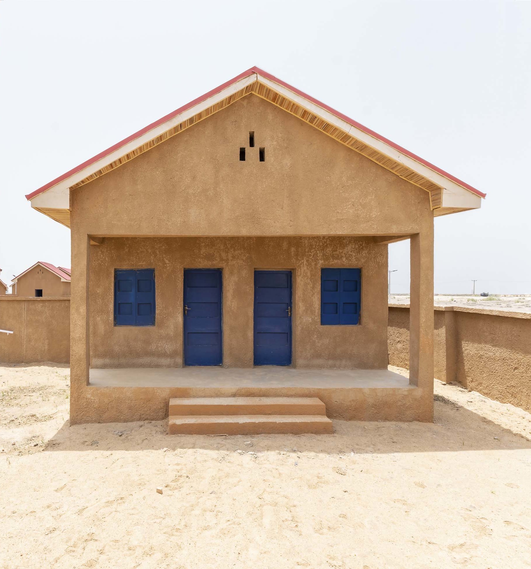 sand house with blue door