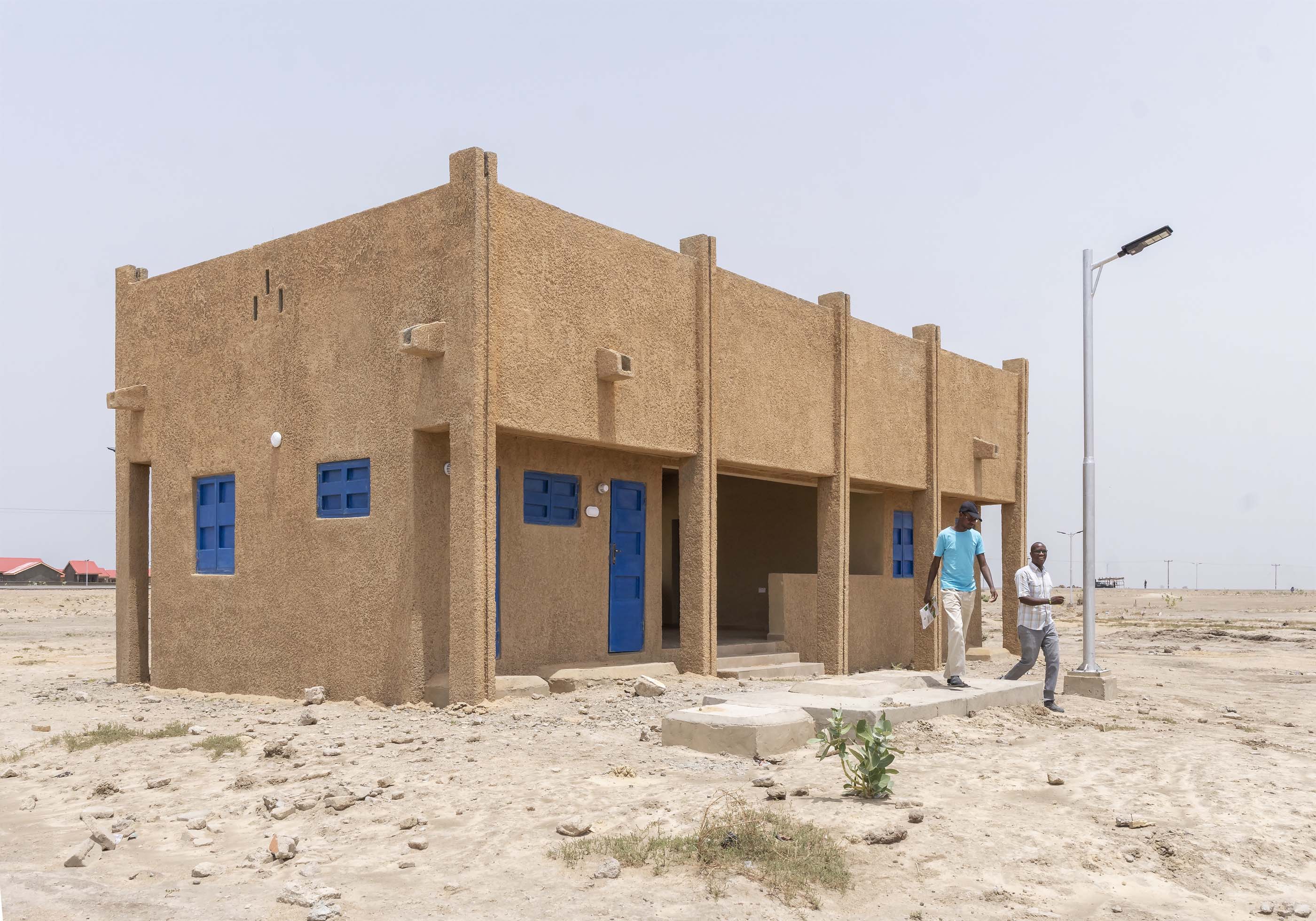 sand building with blue door