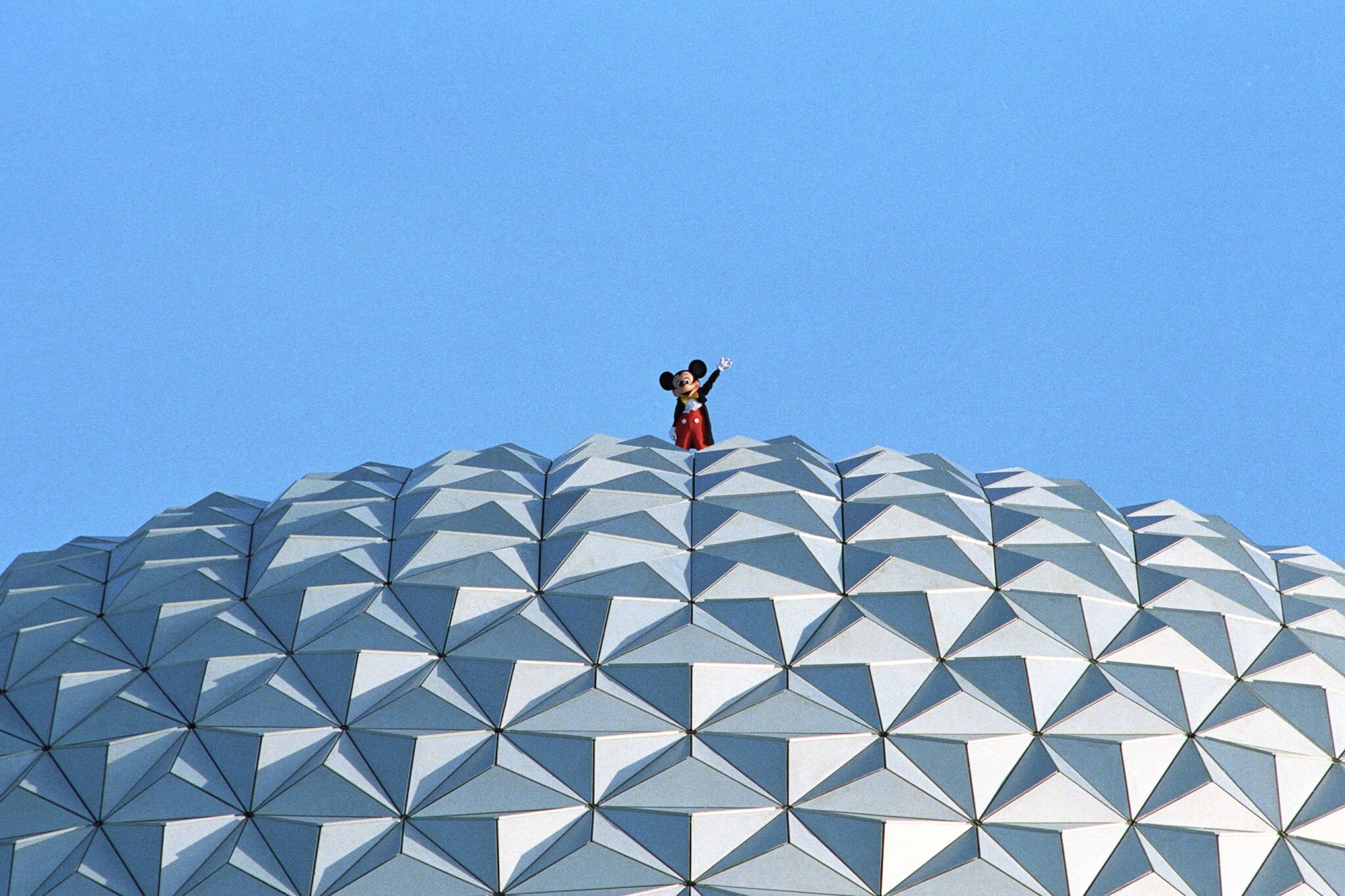 mickey mouse on top of white globe