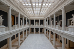 view of a long room dedicated to roman marble statues at the carnegie museum of art
