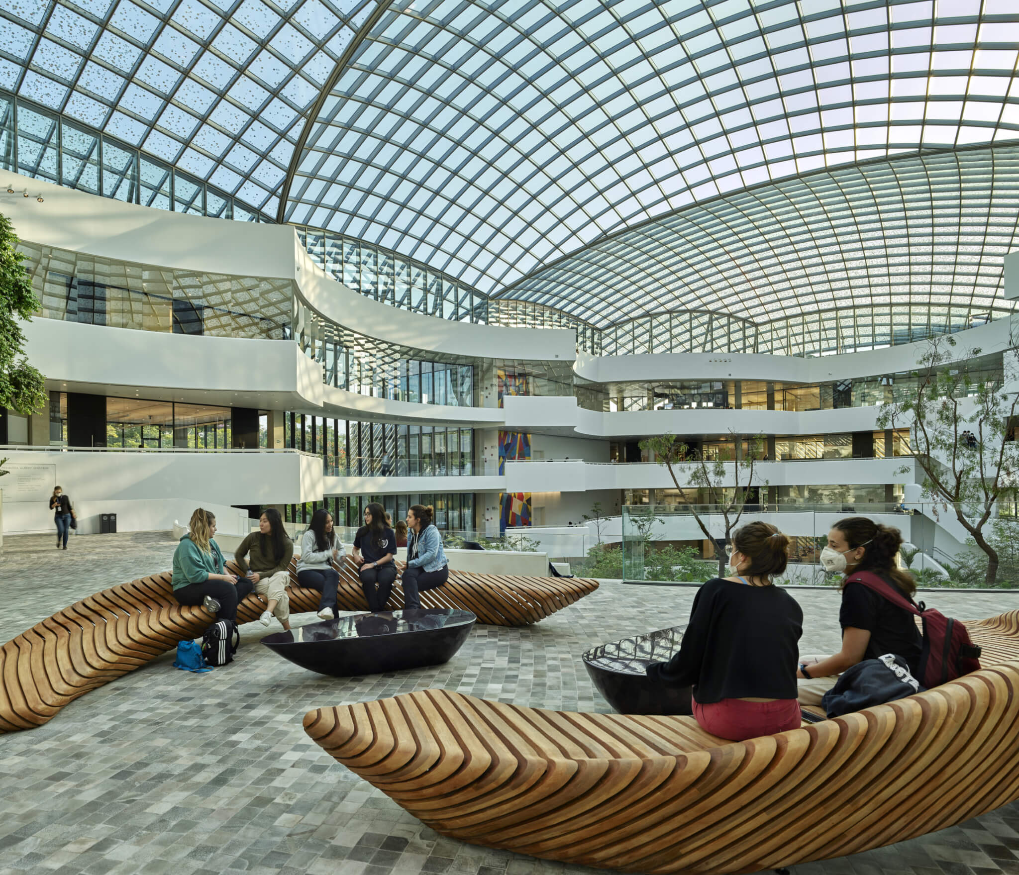 students sitting in an atrium