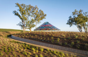 a pavilion with a colorful glass canopy at a vineyard