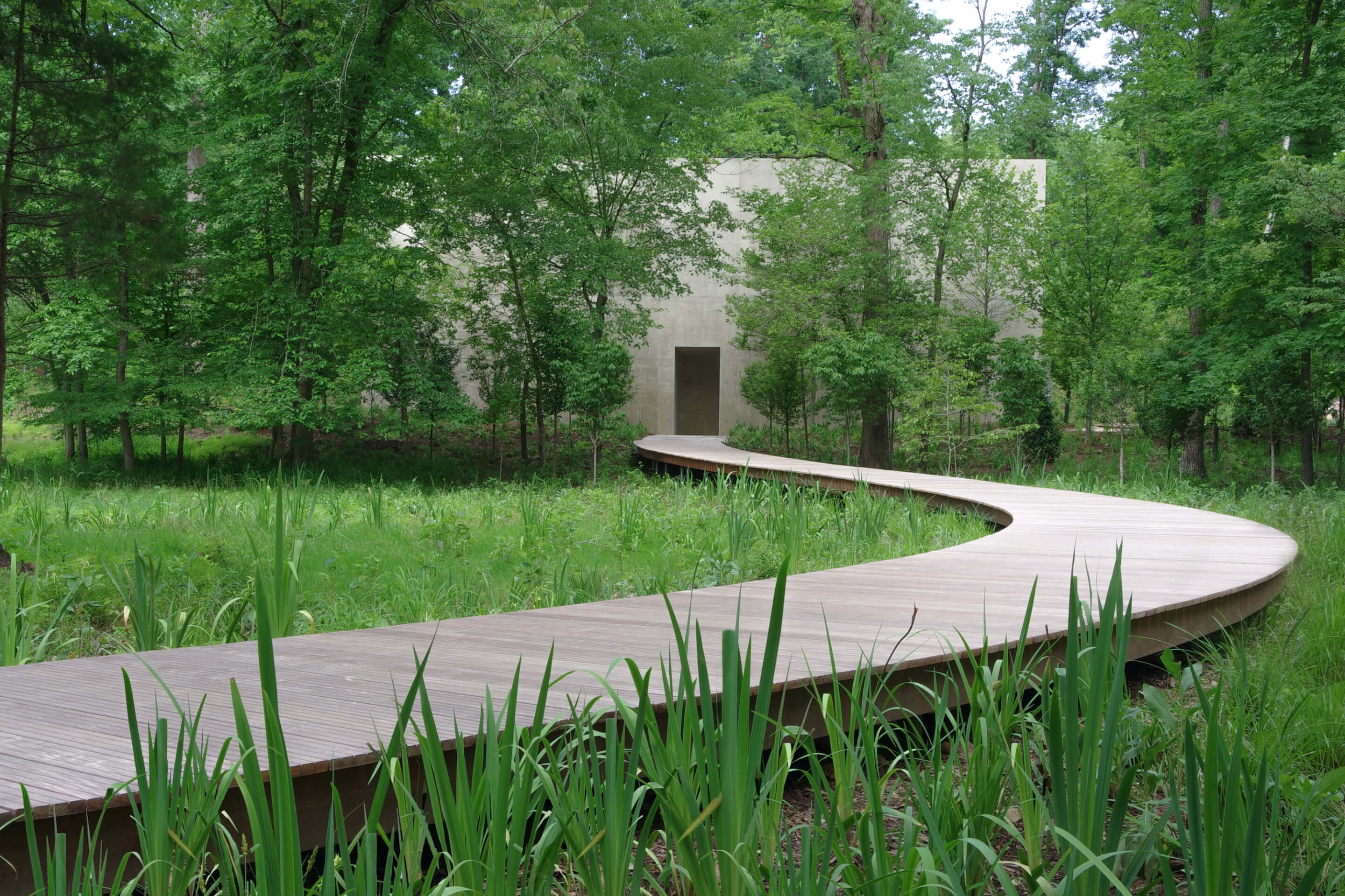 a floating boardwalk leads to a concrete structure