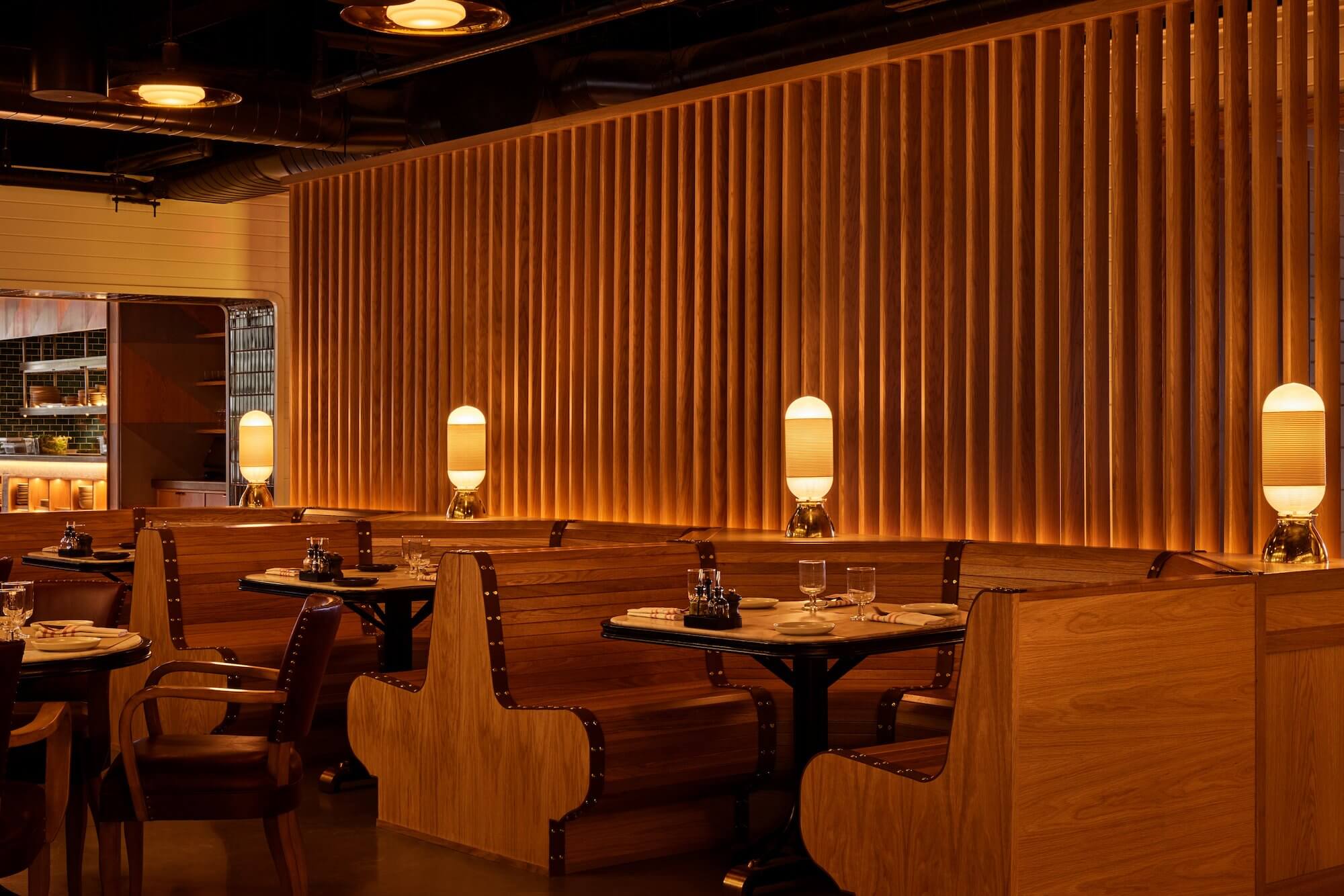 a cozy dining space with curvy wood booths and paneling