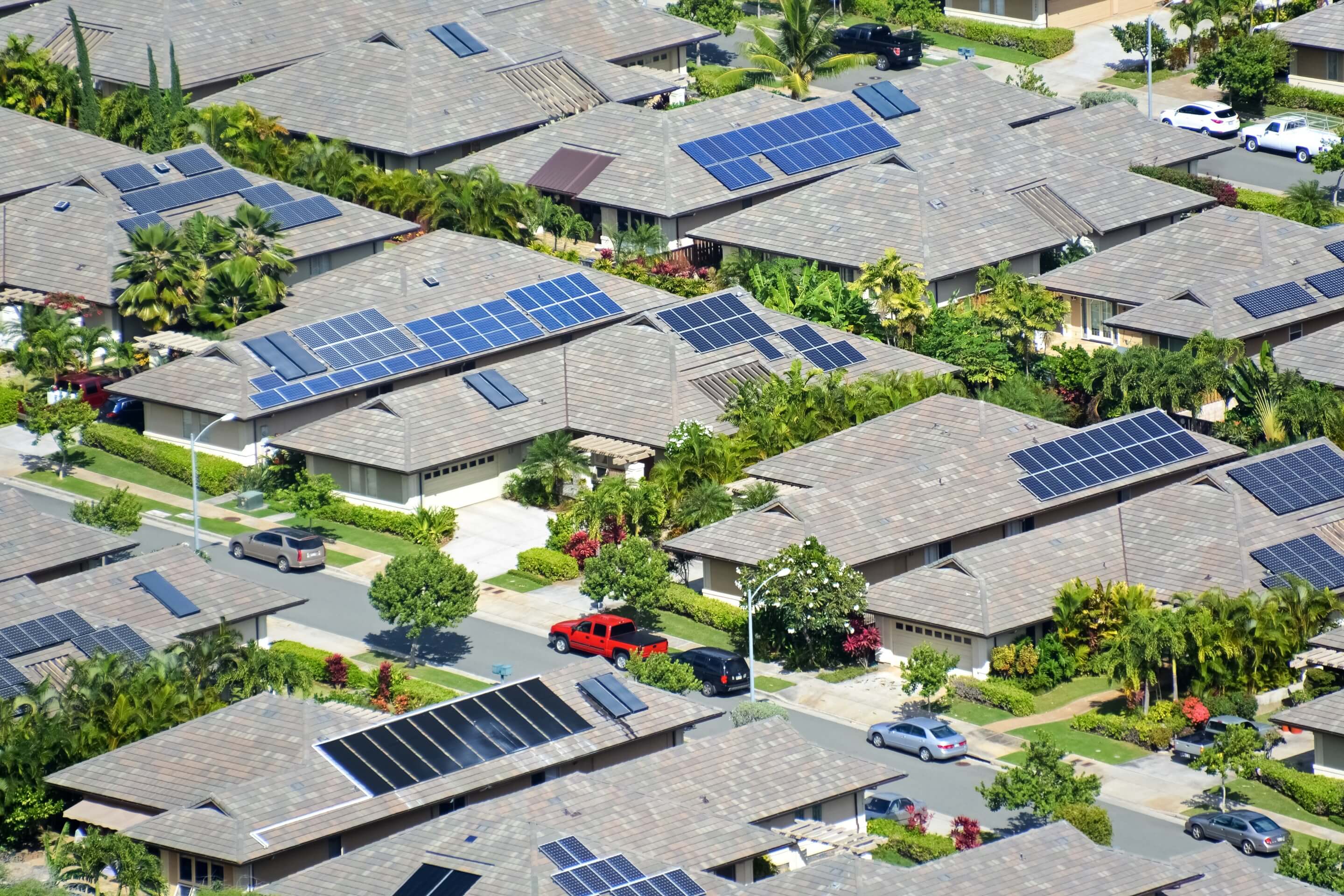 overhead view of homes topped with solar arrays