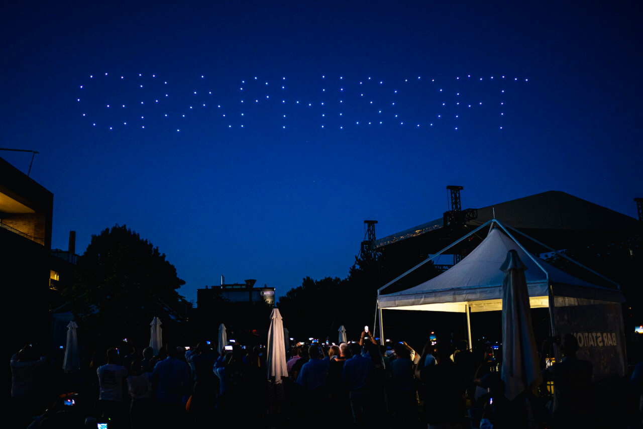 Drones spelling out GRAPHISOFT in the night sky