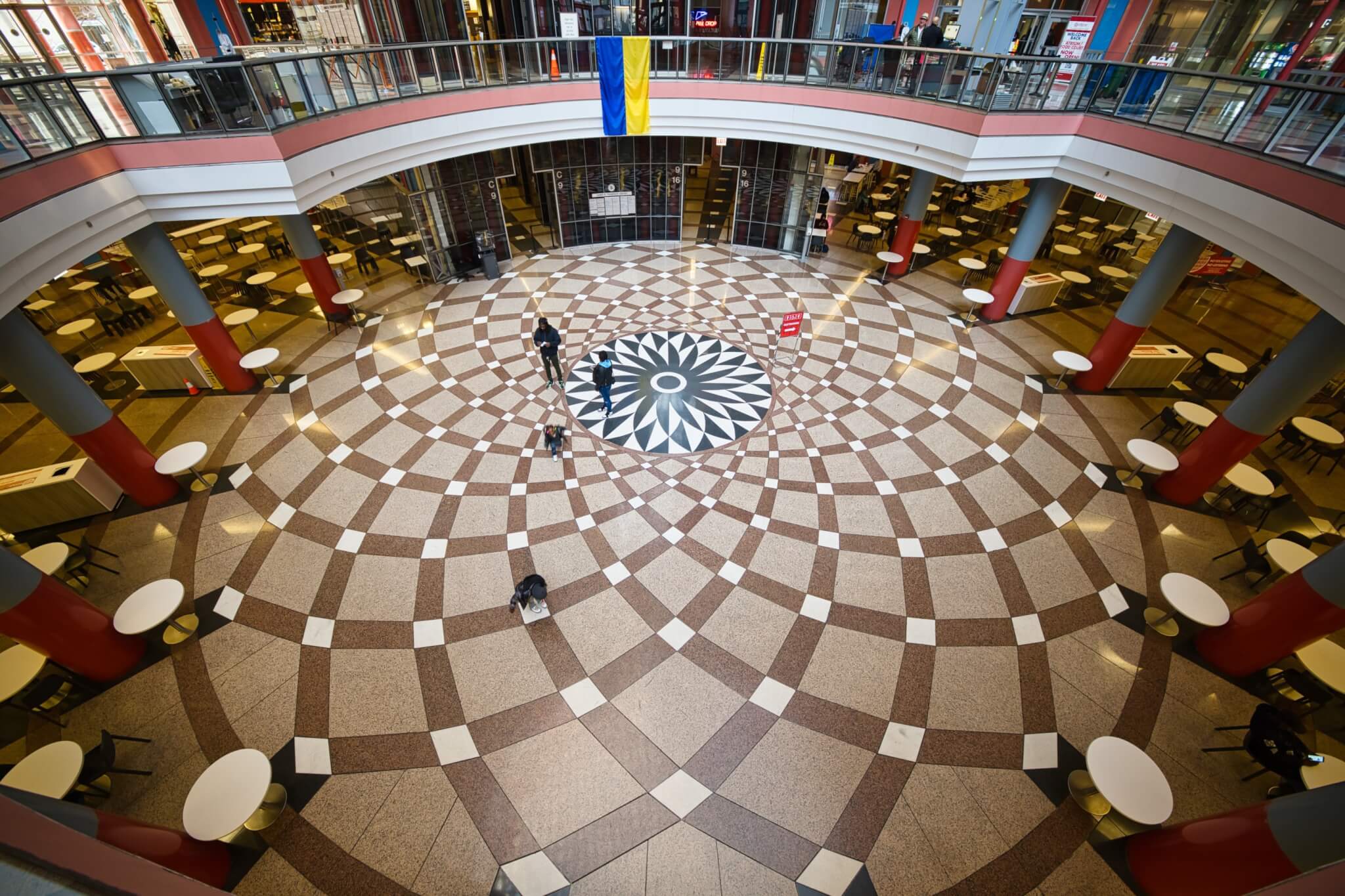 public space at the base of an atrium with tile flooring