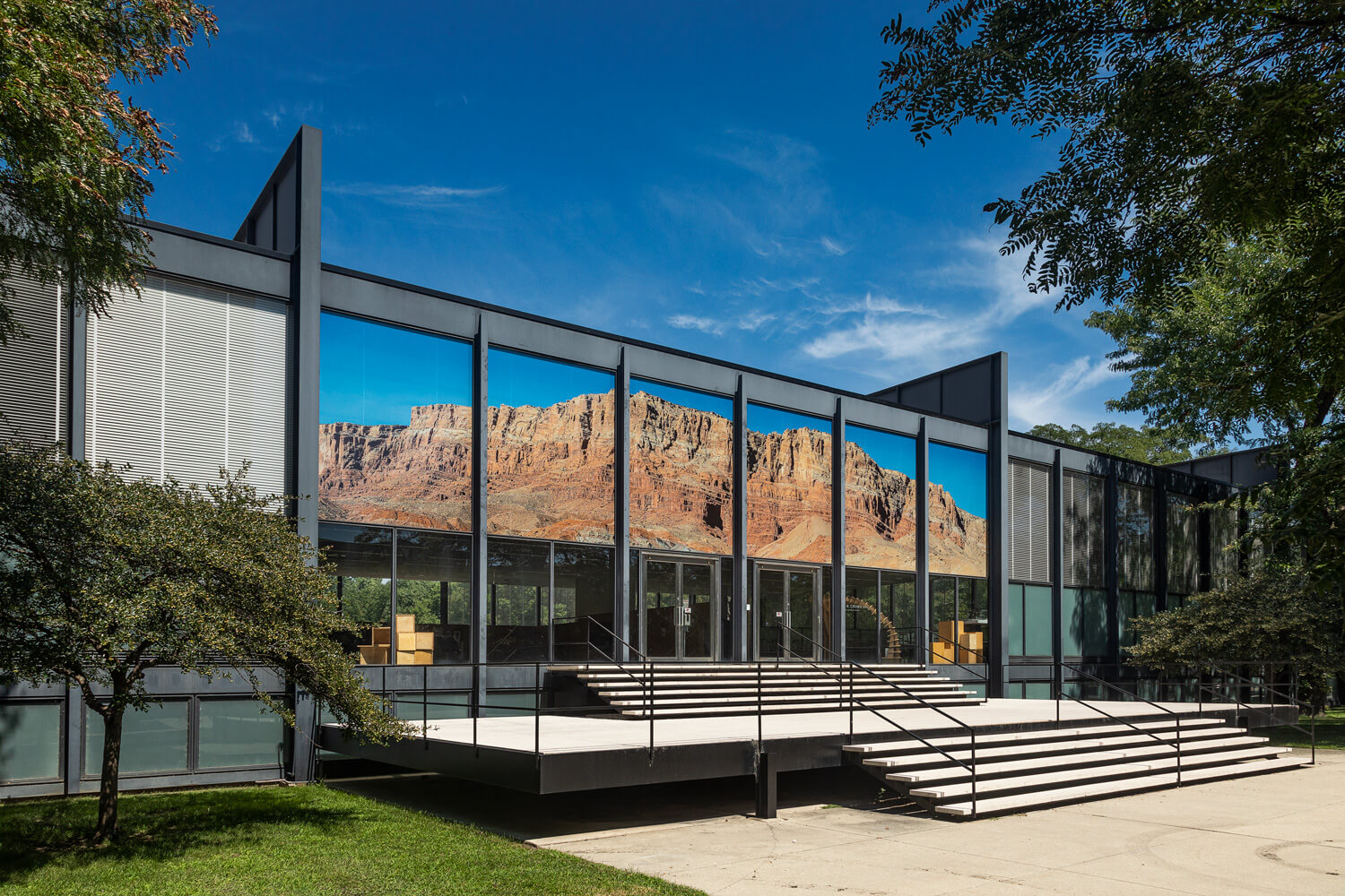 a mountainous collage installed on a mies van er rohe building