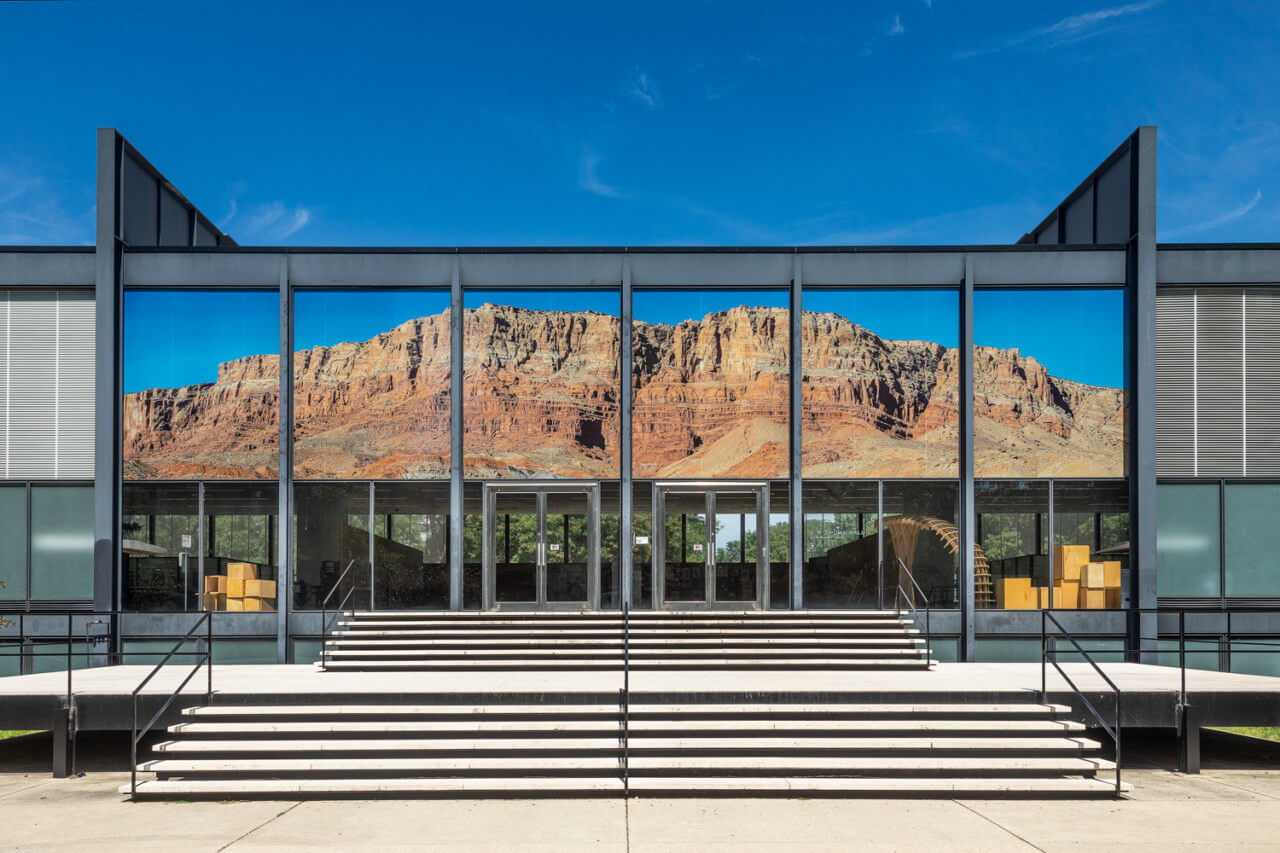 a mountainous collage installed on a mies van er rohe building
