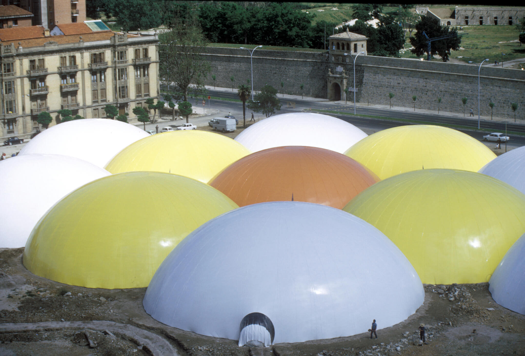 large colored dome structures clustered on a large urban site