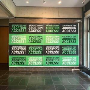 green and black signage promoting abortion access