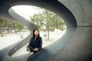 portrait of Meeijin Yoon next to a sculpture