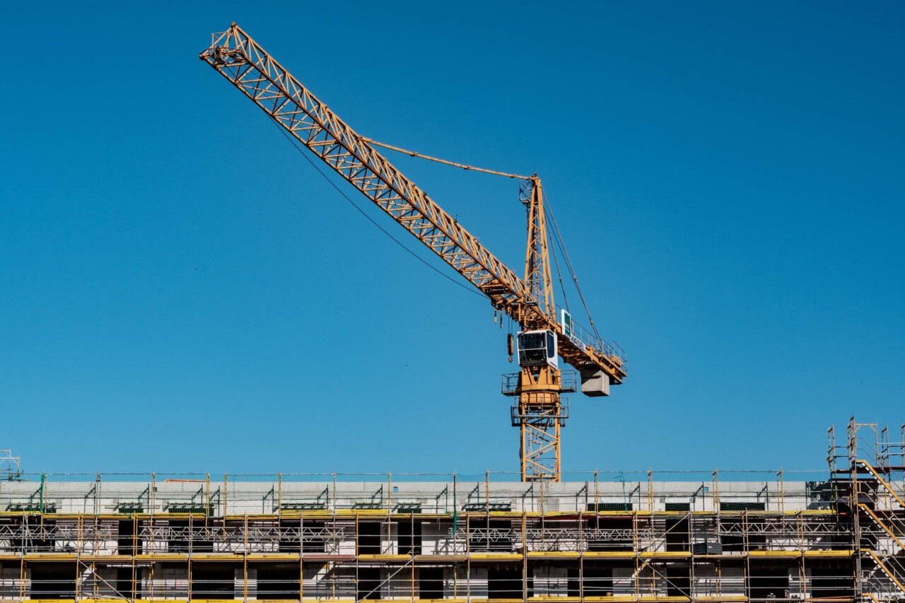 construction crane with scaffolded building