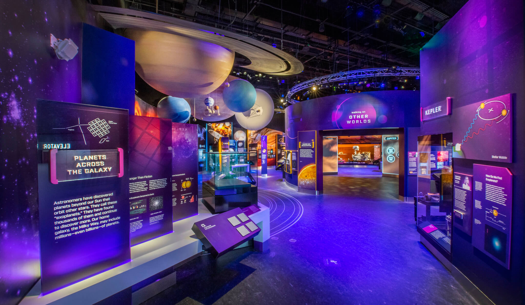 purple lit-up gallery with interactive and digital displays