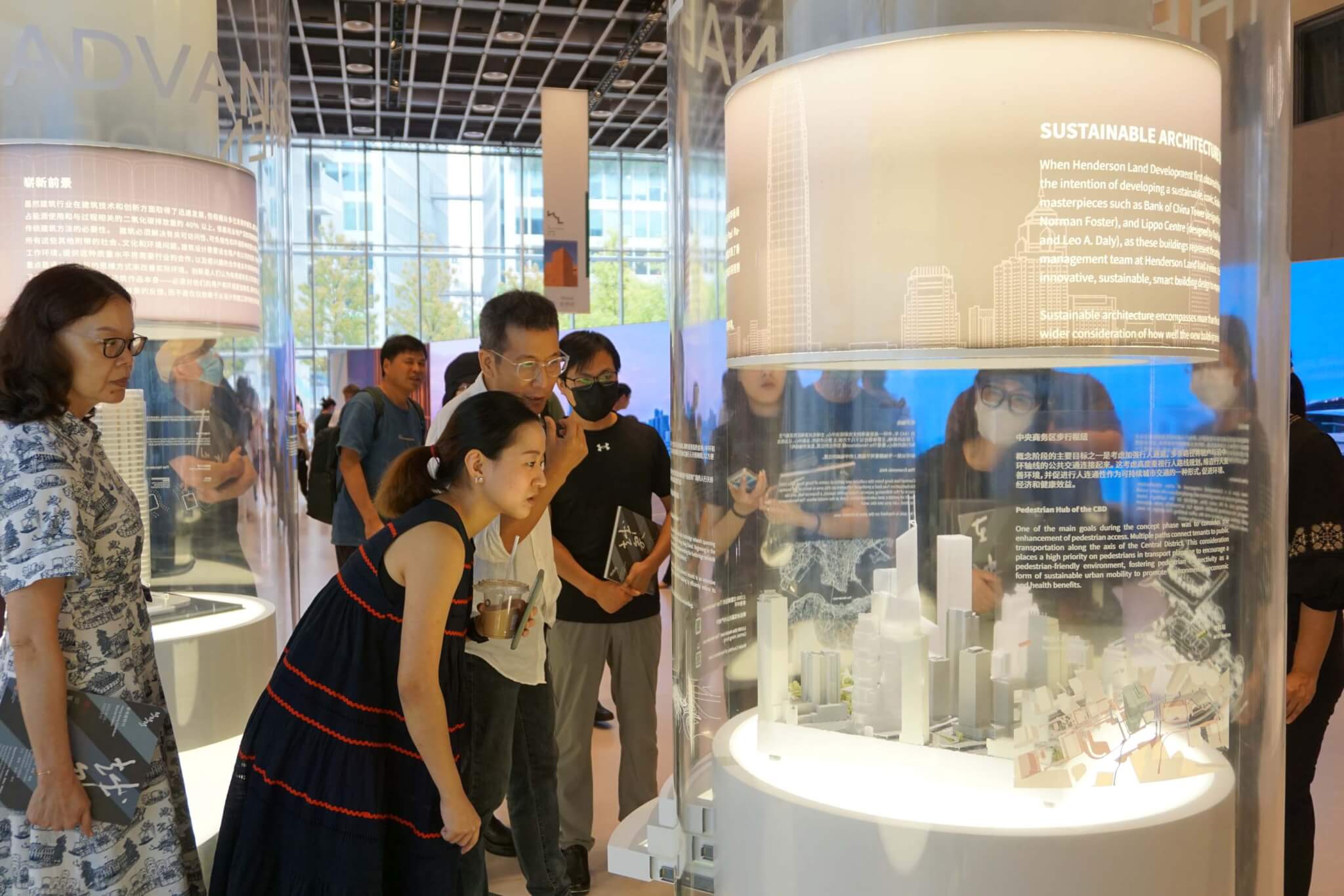 people looking into glass exhibition case