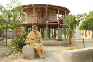yasmeen lari sitting in front of one of her projects