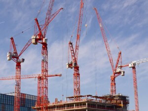 red cranes on building under construction