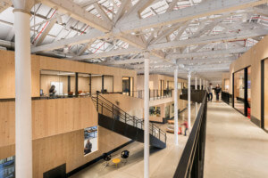 a modern factory space comprised of stacked engineered wood pods