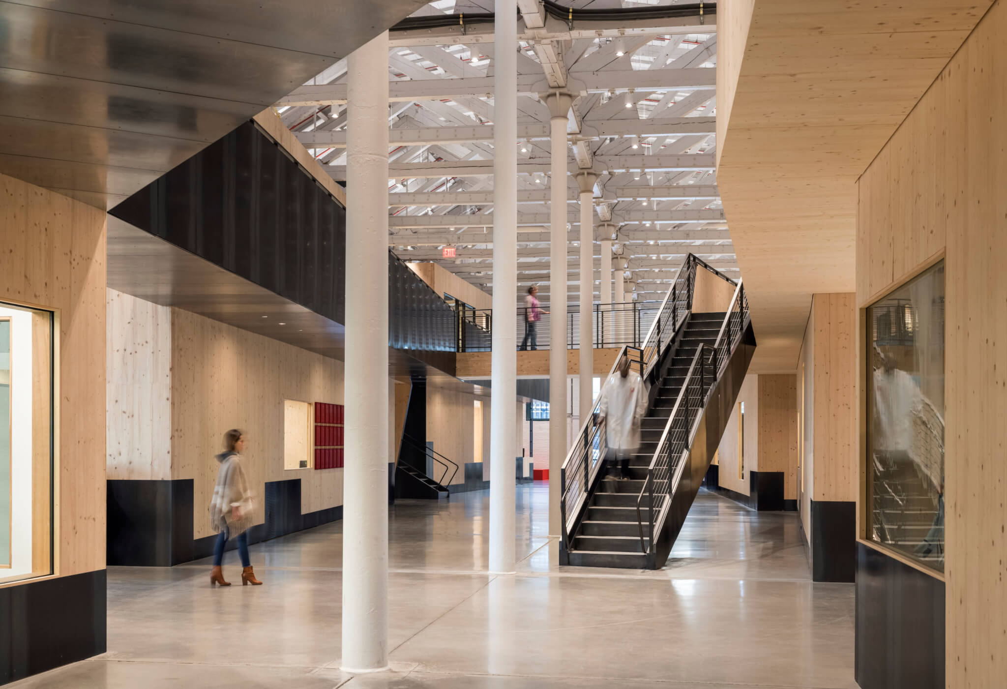 a modern factory space comprised of stacked engineered wood pods