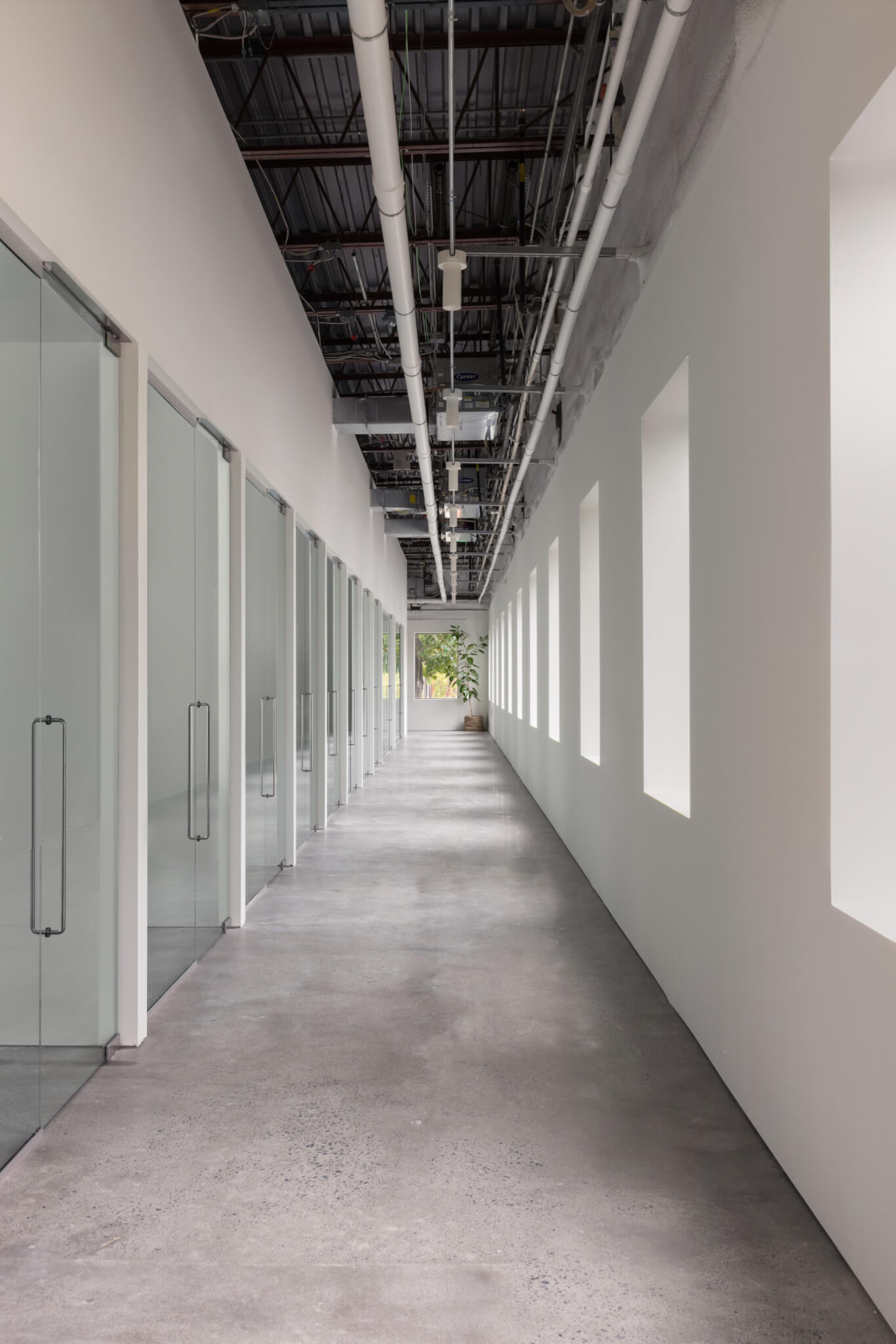 a long corridor of offices in a factory building