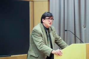 bruno latour standing at a podium giving a lecture