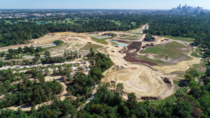aerial shot of a large park with a land bridge under construction in houston