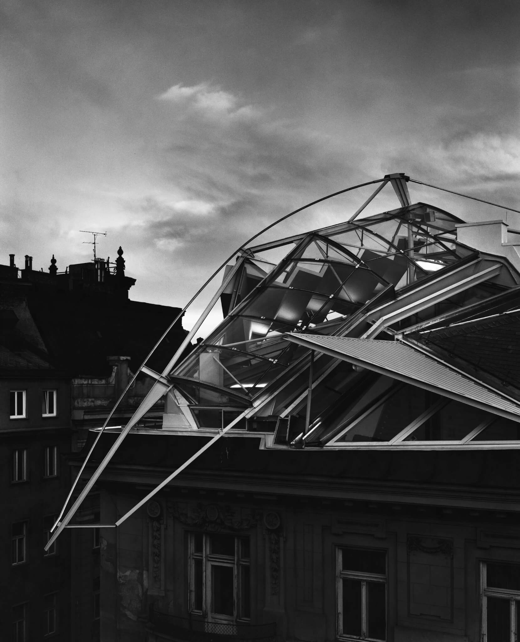 black and white photograph of building on rooftop