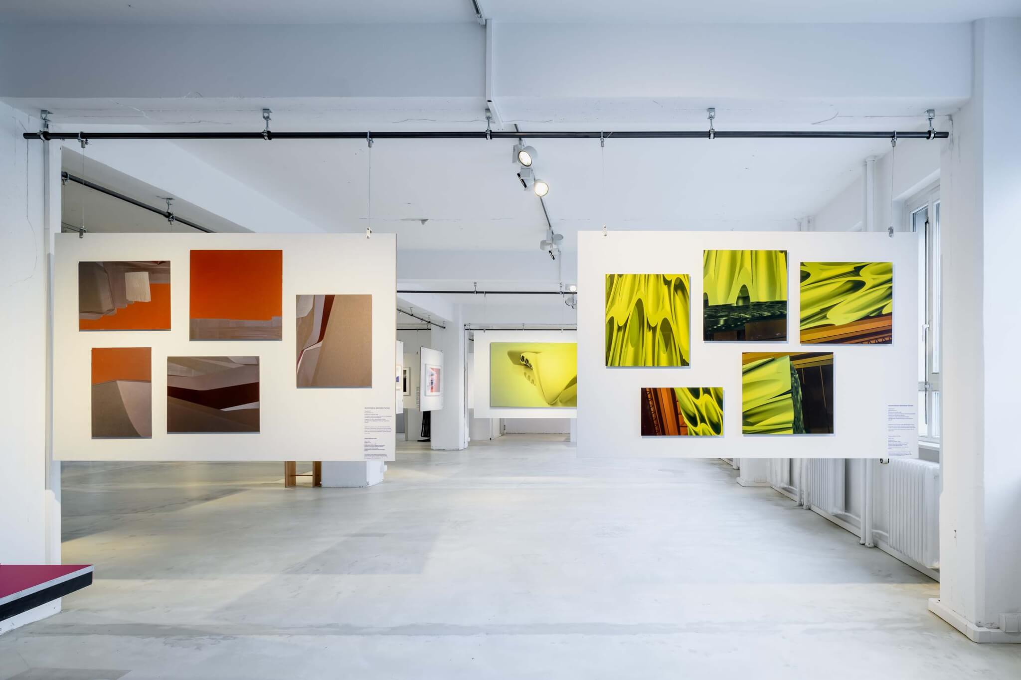 yellow and red architectural drawings in exhibition space