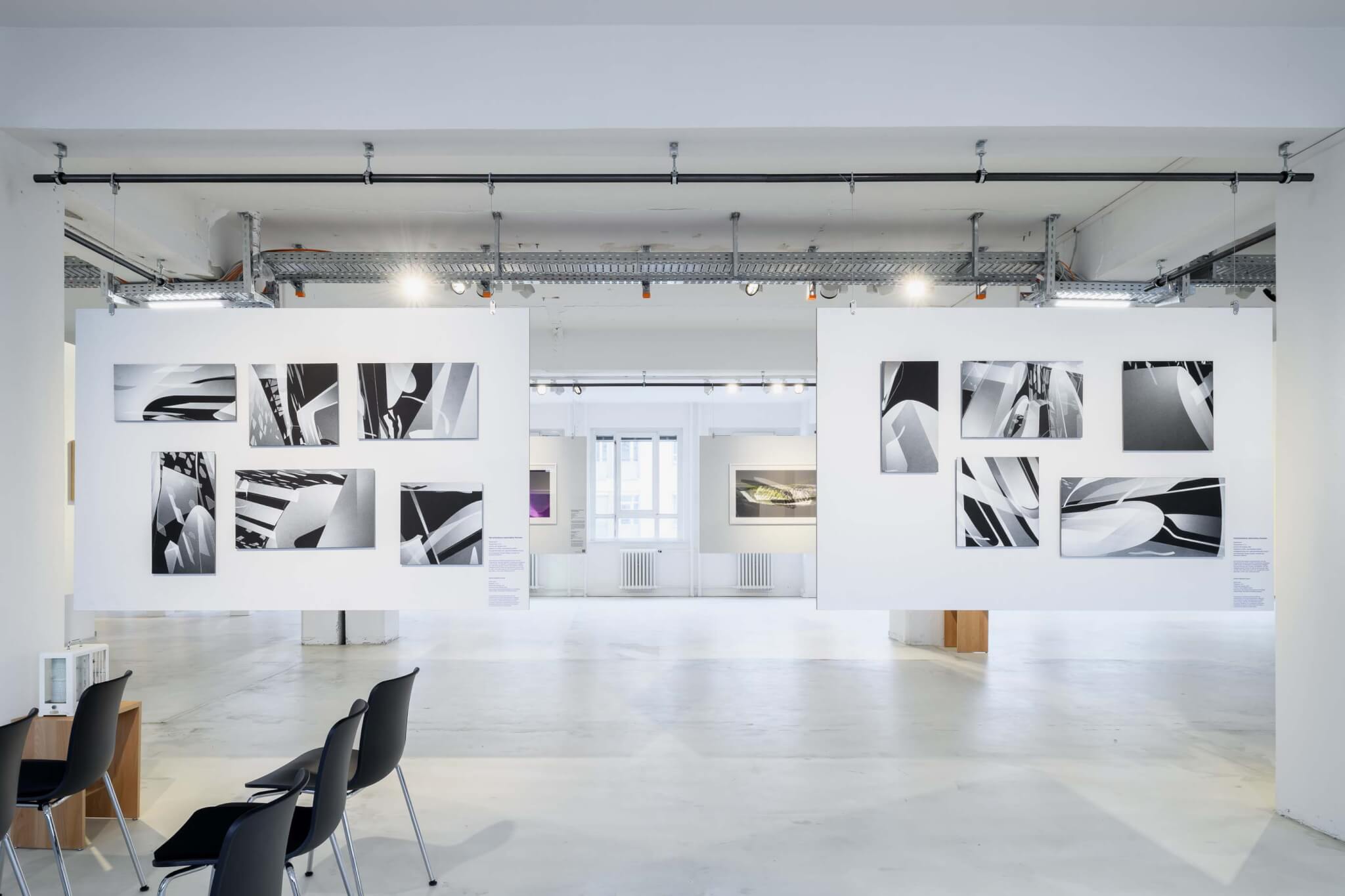 view of exhibition space with architectural drawings on display