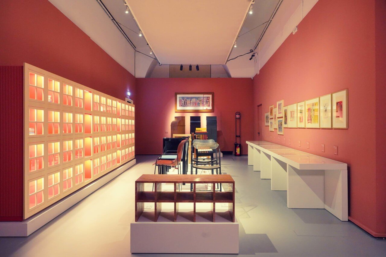 shelving units on display in pink exhibition space