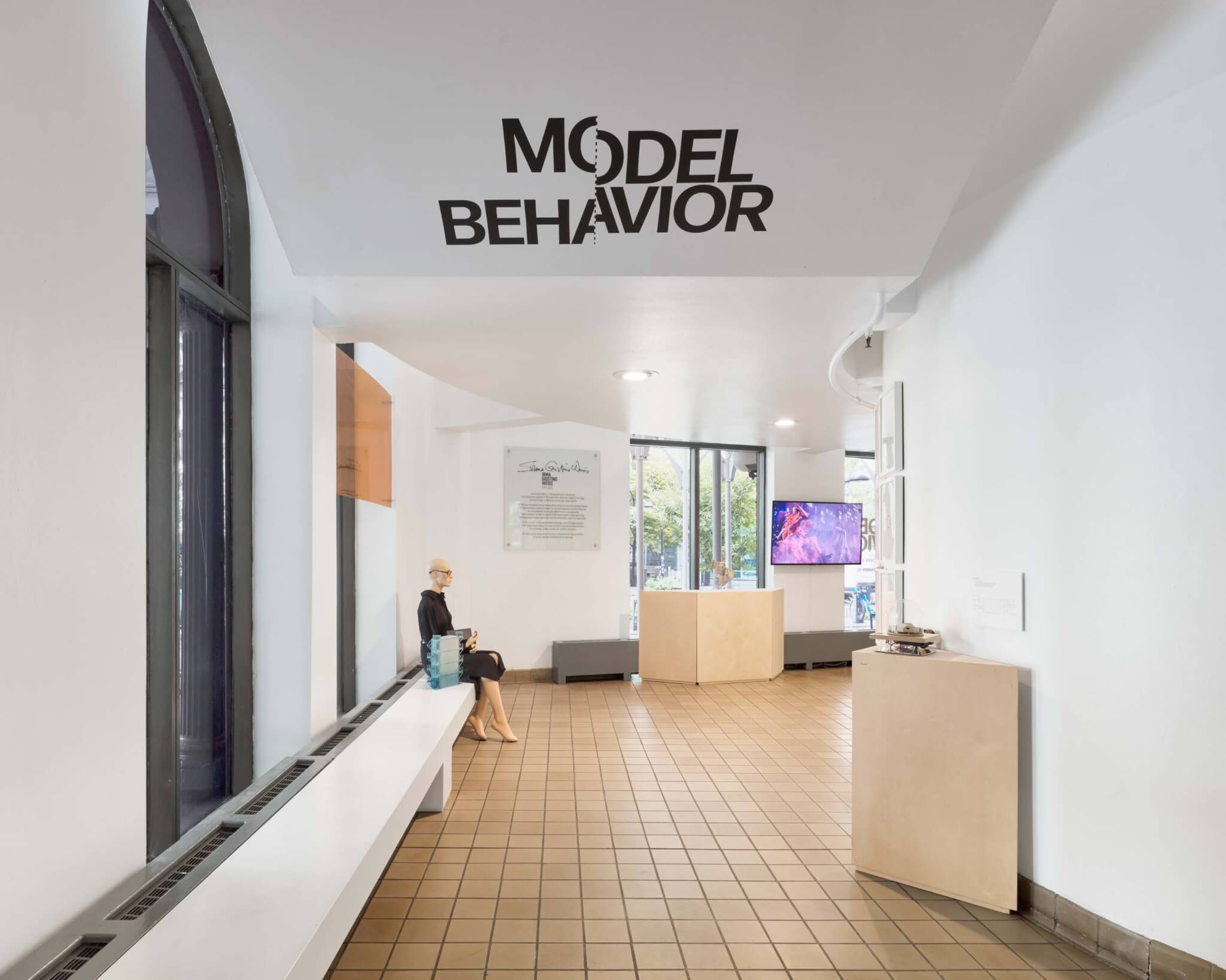 entry to model behavior exhibition with exhibition title text on ceiling