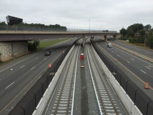 rapid transit tracks pictured alongside a road near dulles airport