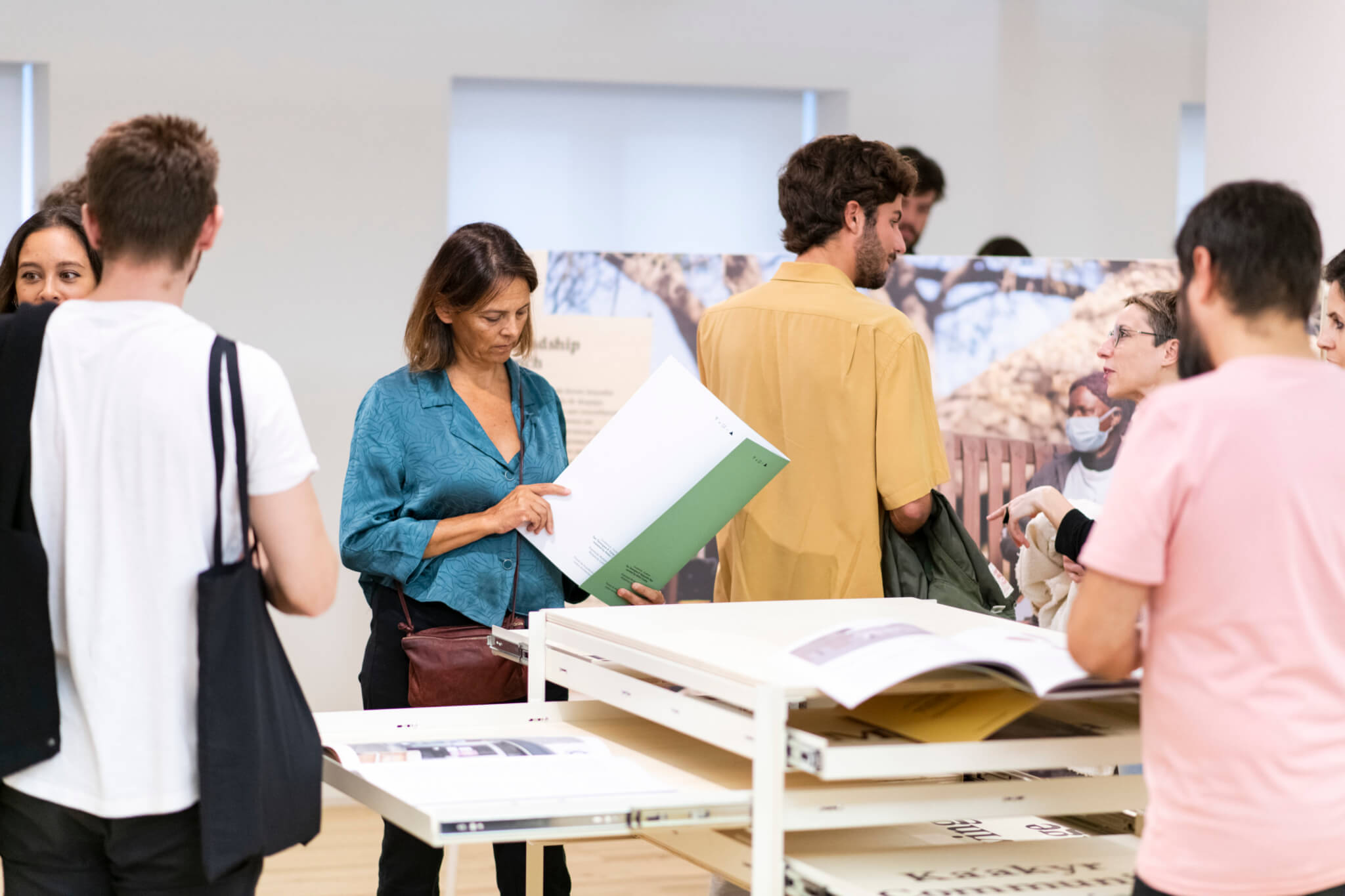 people viewing documents in exhibition