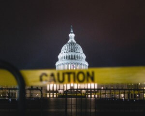 The united states capitol behind caution tape at night
