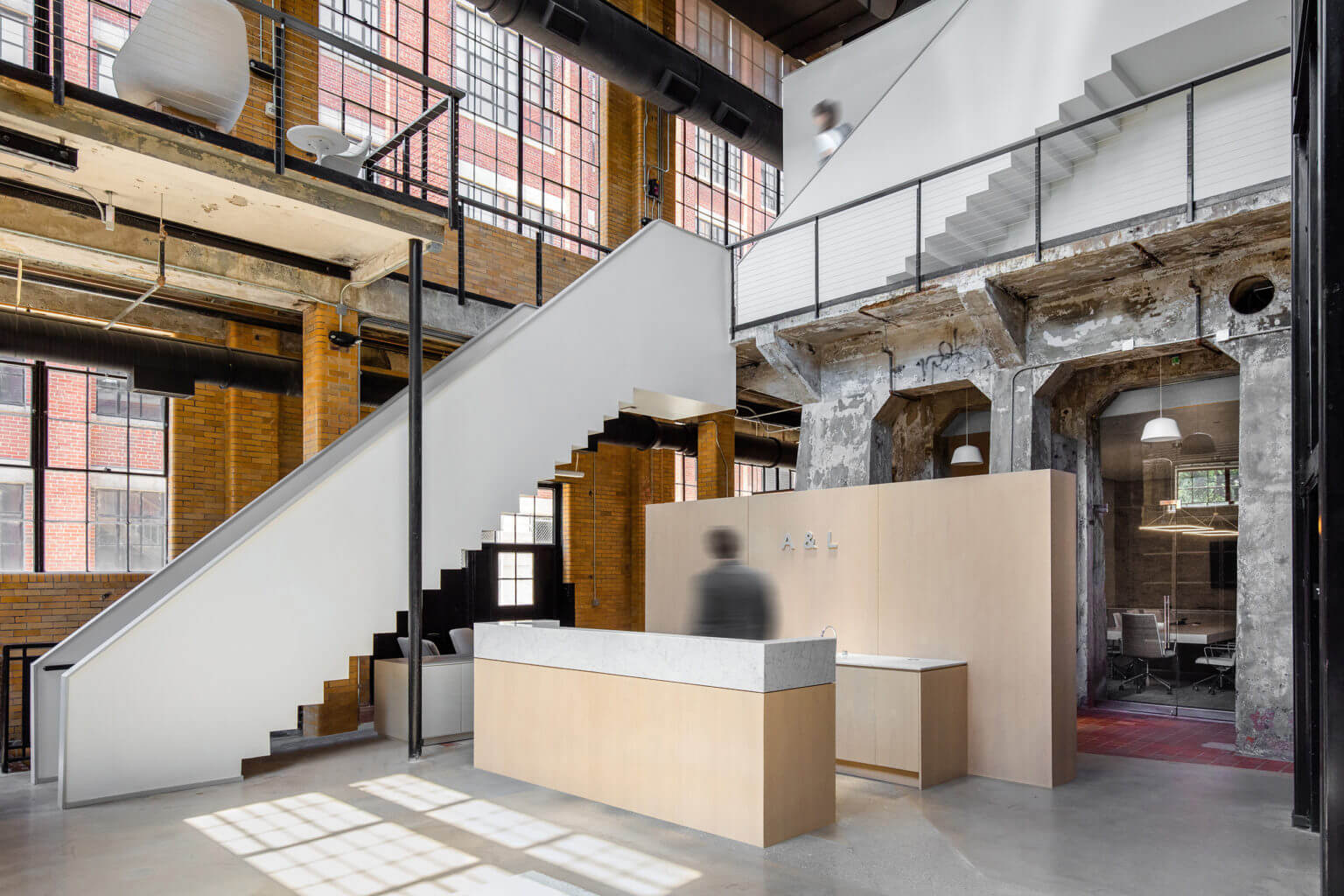 interior view of converted warehouse with stairs and desk