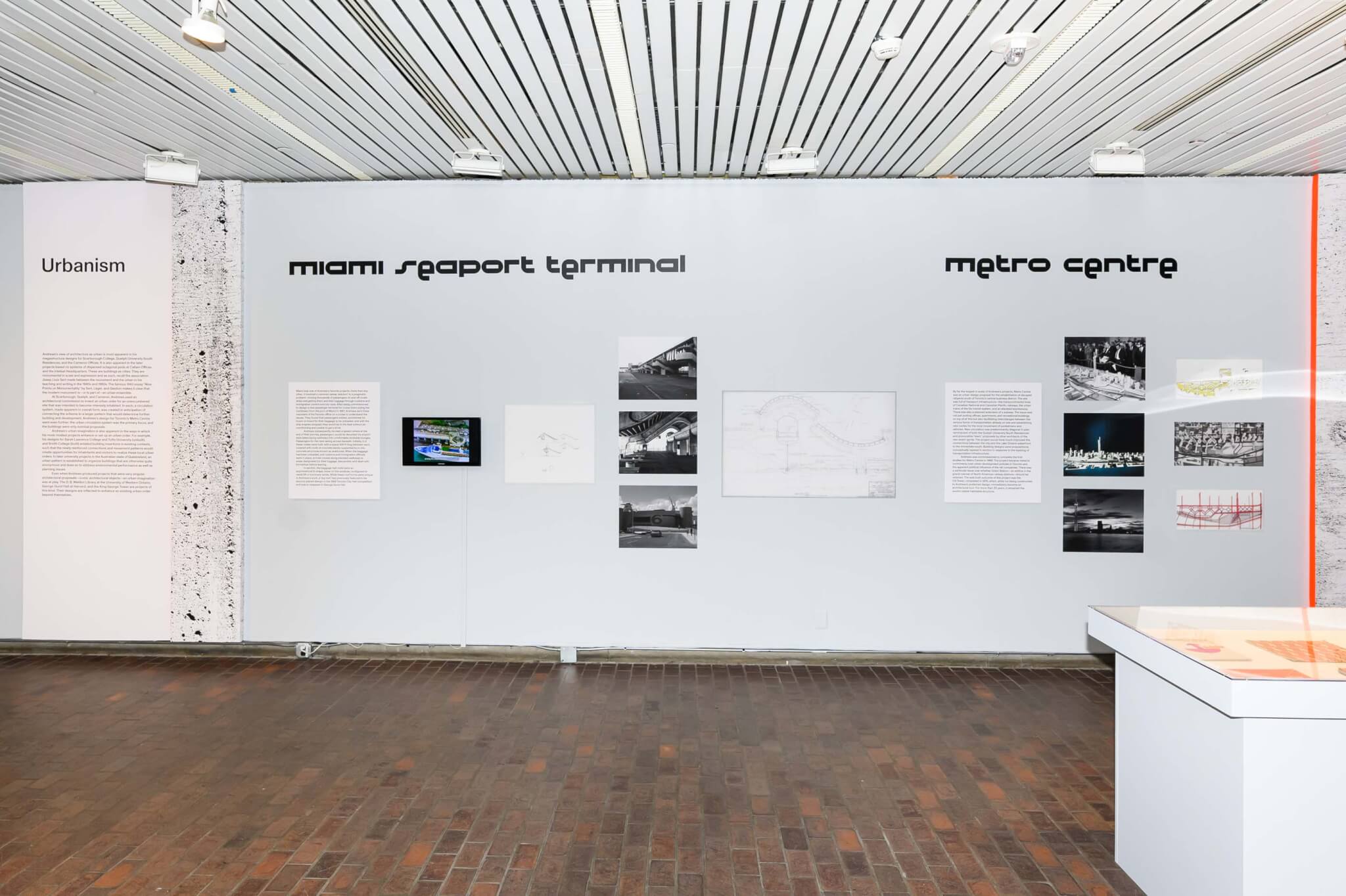 exhibition view with wall text and archival images