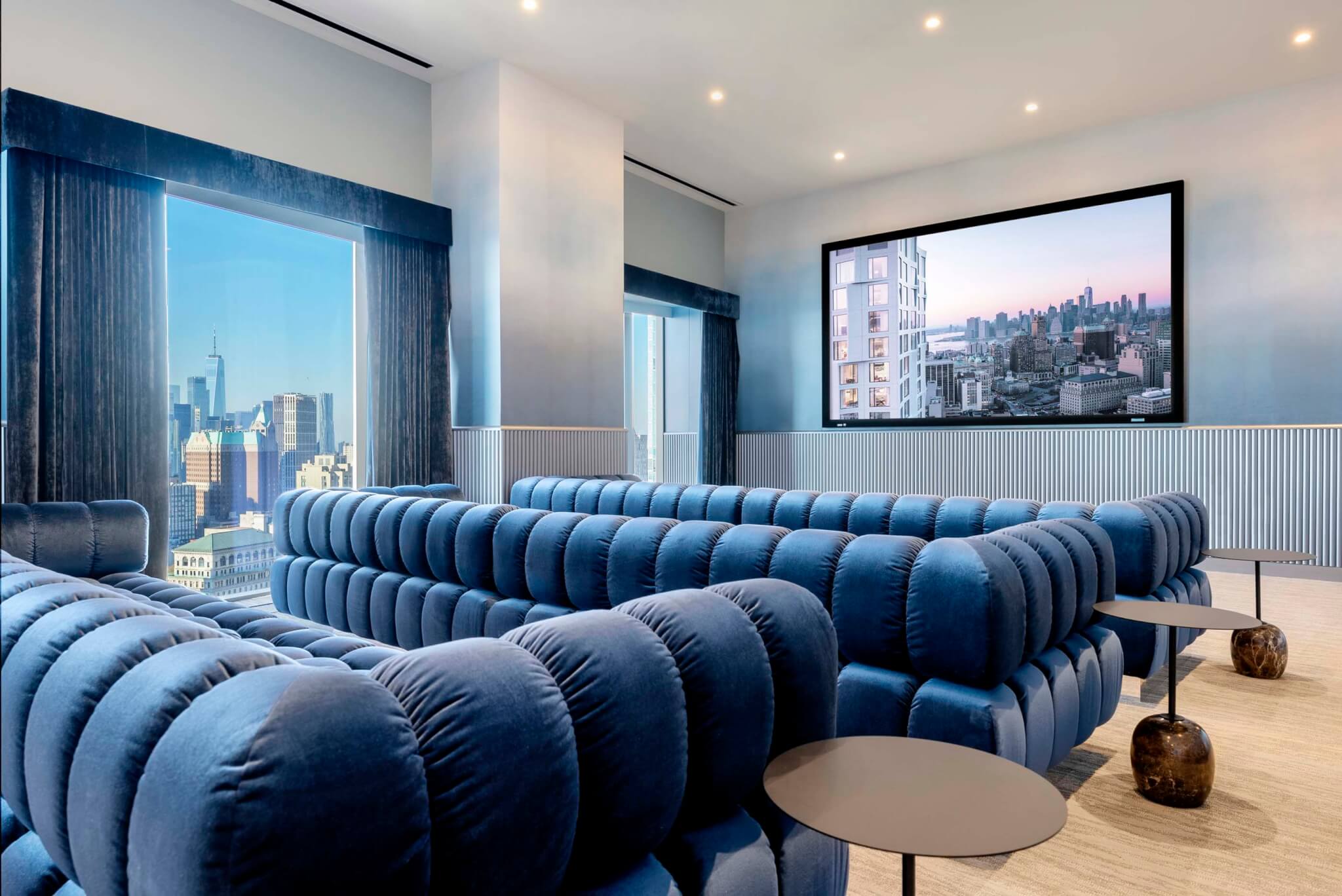 blue sofas with large movie screen