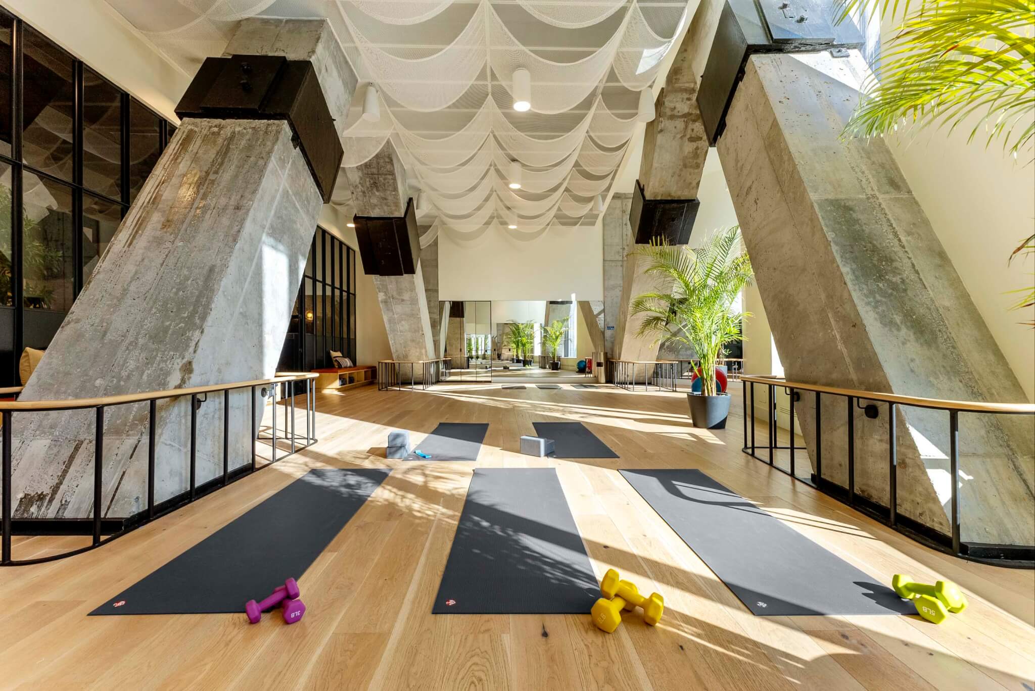 yoga studio with wood floor and mats set up