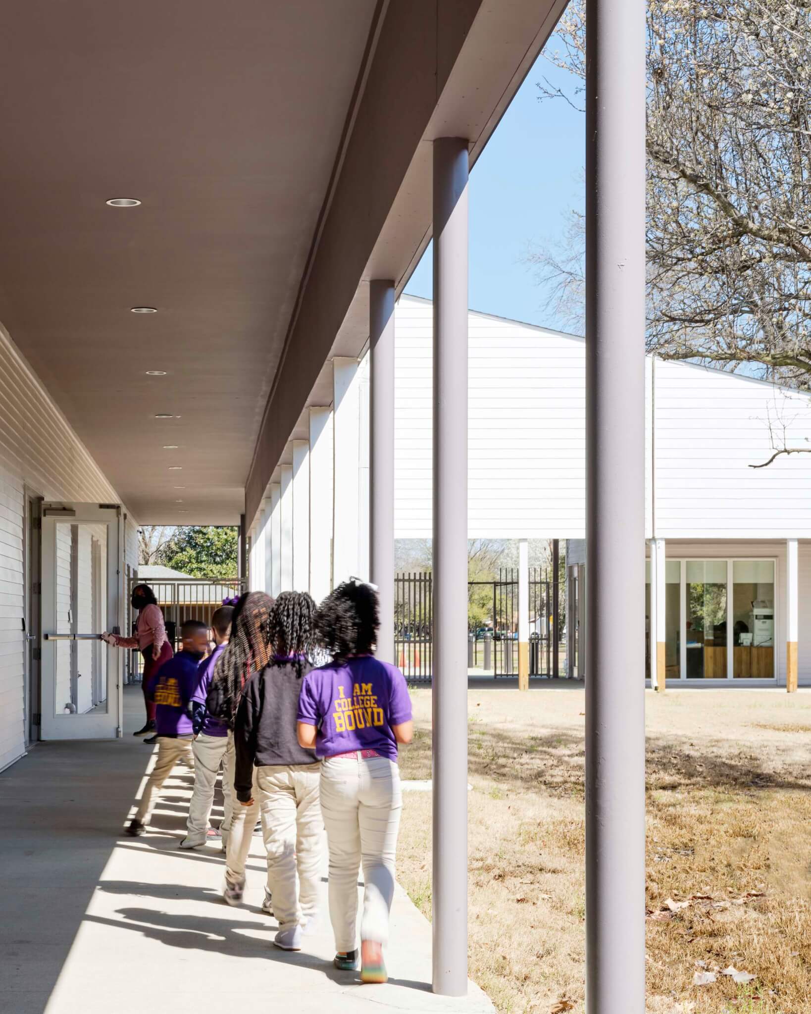 students walk in outside hallway between classes