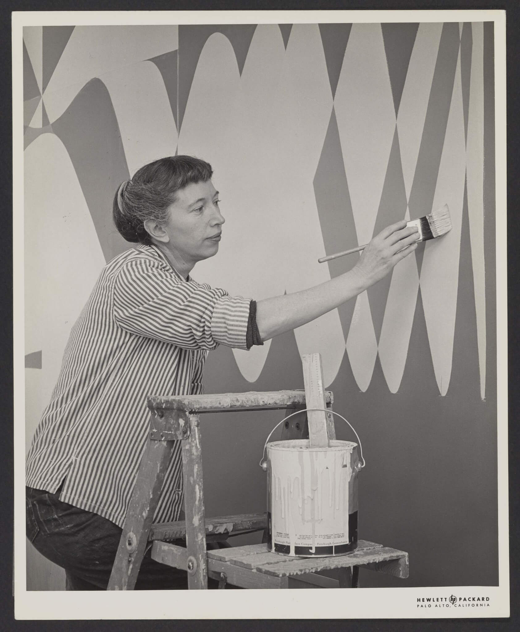 black and white photo of mary dill henry painting mural