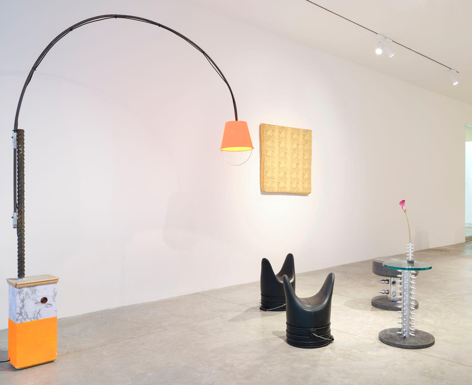 lamp and objects on floor in gallery space
