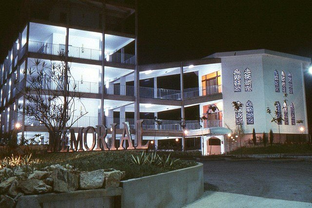 white building with outdoor terraces illuminated at night