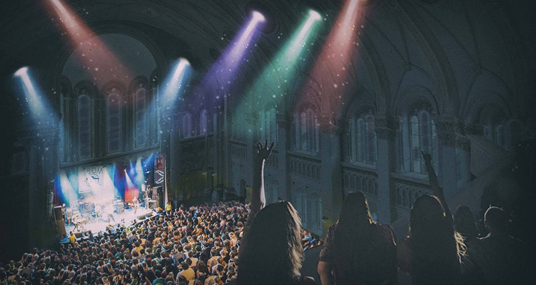 colorful lights and concert crowd inside church