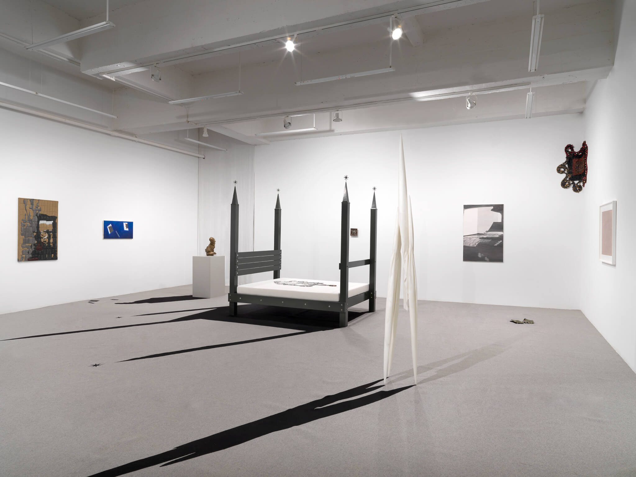 black four post bed staged in gallery