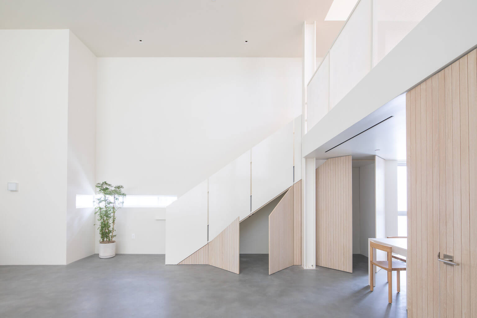 staircase with white walls and wood doorways