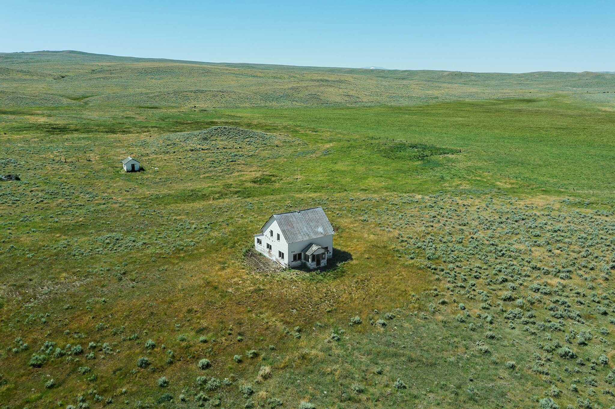 aerial image of house on open grassland