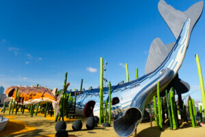 Two giant fish play structures in a park